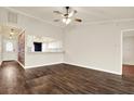 Spacious living room with hardwood floors, high ceilings, and an open view into the kitchen at 4342 Candler Ave, Spring Hill, FL 34609