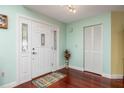 Inviting entryway with hardwood floors, a stylish front door with decorative glass and fresh, clean paint at 460 Meravan Dr, Palm Harbor, FL 34683