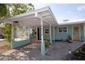 Exterior features a spacious carport with a decorative trellis and inviting entrance at 4830 47Th N Ave, St Petersburg, FL 33714