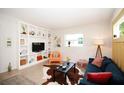 Bright living room with built-in shelving, modern decor, and large windows at 4830 47Th N Ave, St Petersburg, FL 33714