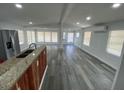 Open-concept living space with modern gray flooring, neutral walls, and abundant natural light at 4851 W Gandy Blvd # B10L30, Tampa, FL 33611