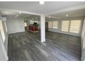 Open-concept living space featuring grey wood floors and neutral paint at 4851 W Gandy Blvd # B10L30, Tampa, FL 33611