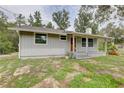 Single-story house showing side and front of house with lots of windows, porch, and chimney at 5290 Cyril Dr, Dade City, FL 33523
