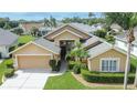 Expansive home featuring mature landscaping, a two-car garage, and a well-manicured lawn, captured from above at 5303 Cottonwood Tree Cir, Valrico, FL 33596