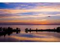 Beautiful sunset reflecting on the bay with islands and trees in silhouette at 6009 Sea Ranch Dr # 306, Hudson, FL 34667
