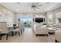 Open-concept living area showcases modern furnishings and a sliding glass door to the outside balcony at 6049 Moorings S Dr, St Petersburg, FL 33712