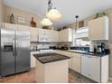 Bright kitchen featuring stainless steel appliances, white cabinets and granite counters, ideal for culinary enthusiasts at 810 Erik Lake Rd, Brandon, FL 33510