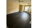 Bedroom with dark wood floors, large window with curtains, and neutral paint at 8517 Island Breeze Ln # 207, Temple Terrace, FL 33637