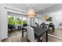 The dining room features modern lighting, a mirror accent wall, and sliding door at 952 Virginia St # 303, Dunedin, FL 34698
