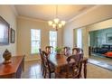 Traditional dining room with wooden table, chandelier, and decorative artwork on the walls at 11038 Spring Point Cir, Riverview, FL 33579