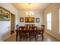Traditional dining room with wooden table, chandelier, and decorative artwork on the walls at 11038 Spring Point Cir, Riverview, FL 33579
