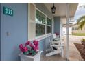 Welcoming porch with seating and flower pots at 111 Carlyle Dr, Palm Harbor, FL 34683