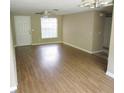 Spacious living room featuring hardwood floors, neutral paint, a ceiling fan, and a bright window at 12615 Logan Pl, Tampa, FL 33625