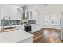 Modern kitchen with stainless steel appliances, white cabinets, and stylish backsplash at 137 Silver Falls Dr, Apollo Beach, FL 33572