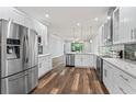 Bright, updated kitchen with a stainless steel refrigerator and open layout at 137 Silver Falls Dr, Apollo Beach, FL 33572