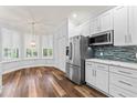 Well-lit kitchen featuring stainless steel appliances, white cabinetry, and a cozy dining area at 137 Silver Falls Dr, Apollo Beach, FL 33572