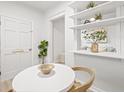 Dining area showcases open shelving and complements the modern white decor throughout the home at 1401 30Th N Ave, St Petersburg, FL 33704