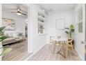 Bright dining area features a round table, open shelving and seamless flow into living space at 1401 30Th N Ave, St Petersburg, FL 33704