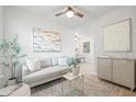 Bright living room features a plush gray sofa and stylish decor with an open view into dining area at 1401 30Th N Ave, St Petersburg, FL 33704
