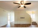 Inviting living room featuring neutral paint, modern ceiling fan, and beautiful laminate flooring at 1421 Dew Bloom Rd, Valrico, FL 33594