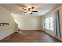 Spacious living room featuring wood floors, neutral walls, and a ceiling fan at 1421 Dew Bloom Rd, Valrico, FL 33594