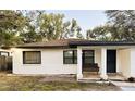 Charming single-story home with a cozy front porch and neutral-colored stucco exterior at 1515 E Hanna Ave, Tampa, FL 33610