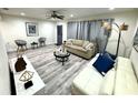 Bright and airy living room with hardwood floors, stylish furniture, and ample natural light at 1515 E Hanna Ave, Tampa, FL 33610