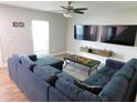 Cozy living room features modern furniture, two TVs, and updated flooring at 15916 Marshfield Dr, Tampa, FL 33624