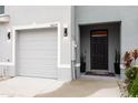 Welcoming entrance to this townhome featuring a one-car garage, and a covered porch at 16624 Maude Dr, Wimauma, FL 33598