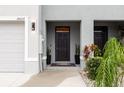 The cozy front entrance to this townhome features a covered porch at 16624 Maude Dr, Wimauma, FL 33598