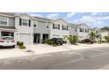 Well maintained townhomes featuring a one car garage, neutral paint, and landscaped front yards at 16624 Maude Dr, Wimauma, FL 33598