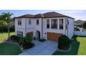 Stately two-story home with a well-manicured lawn, lush landscaping, and attached two-car garage at 1947 Marshberry Ct, Trinity, FL 34655