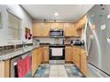 Cozy kitchen featuring stainless steel appliances, granite countertops and light wood cabinetry at 213 Draw Bridge Ln, Valrico, FL 33594