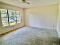 Bedroom with large window allowing for natural light and ceiling fan at 2391 Sumatran Way # 37, Clearwater, FL 33763
