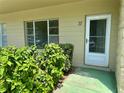 Home entrance with the number 37 above the white door and a window to the left at 2391 Sumatran Way # 37, Clearwater, FL 33763