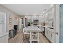 Bright kitchen featuring white cabinets, stainless steel appliances, and a center island at 2824 Paddock Dr, Palm Harbor, FL 34684