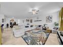 Spacious living room with tile floors, a ceiling fan, and comfortable seating with stylish decorations at 3216 Bryant Park Dr, New Port Richey, FL 34655