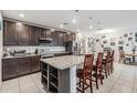 Open kitchen with granite countertops, dark cabinets, stainless steel appliances, and a center island at 344 Dartmouth Ave, Spring Hill, FL 34606