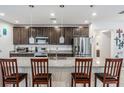 Spacious kitchen features granite counters, dark cabinets, pendant lighting and stainless appliances at 344 Dartmouth Ave, Spring Hill, FL 34606