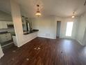 Dining area and open bar with an outdoor view, neutral walls, and hanging lights at 3541 65Th Avenue E Cir, Sarasota, FL 34243