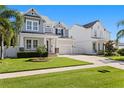 Charming two-story home features a manicured lawn and covered front porch, enhancing its curb appeal at 3605 W Dale Ave, Tampa, FL 33609