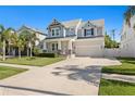 Charming two-story home features a manicured lawn and covered front porch, enhancing its curb appeal at 3605 W Dale Ave, Tampa, FL 33609