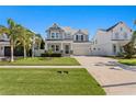 Charming two-story home features a manicured lawn and covered front porch, enhancing its curb appeal at 3605 W Dale Ave, Tampa, FL 33609