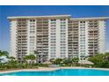 Beautiful condo featuring a serene pool surrounded by lounge chairs and lush landscaping at 400 Island Way # 1606, Clearwater Beach, FL 33767