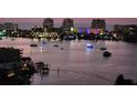 Water view of boats decorated with lights at night from the condo overlooking the bay at 400 Island Way # 1606, Clearwater Beach, FL 33767