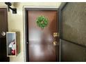 Welcoming front door with wreath, ensuring safety with a fire extinguisher box mounted nearby at 4215 E Bay Dr # 1707C, Clearwater, FL 33764