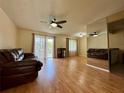 Bright living room with gleaming floors, ceiling fan, balcony access, and ample seating, perfect for relaxation at 4215 E Bay Dr # 1707C, Clearwater, FL 33764