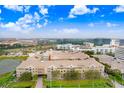 Aerial view of condo building with trees and other buildings in the background on a partly cloudy day at 4221 W Spruce St # 1429, Tampa, FL 33607