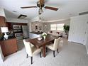 Open-concept living area with a dining table, stainless steel appliances, and lots of natural light at 6081 22Nd N Ave, St Petersburg, FL 33710
