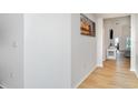 Bright hallway featuring light wood floors and neutral paint, leading to the living area at 6226 165Th E Dr, Parrish, FL 34219